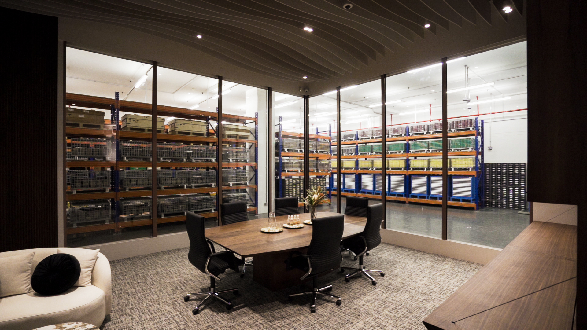 Meeting room with glass walls overlooking BullionStar's precious metals storage vault inside Le Freeport Singapore