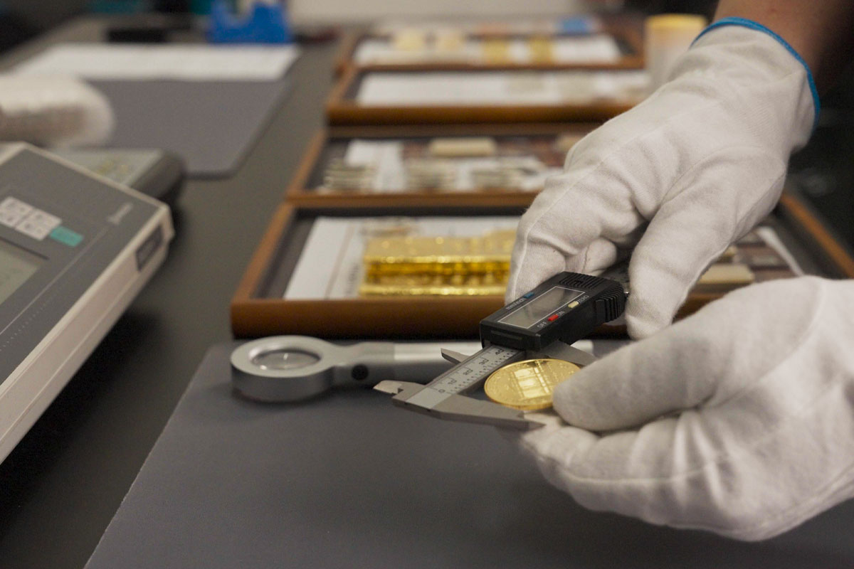 Gold being measured with Calipers