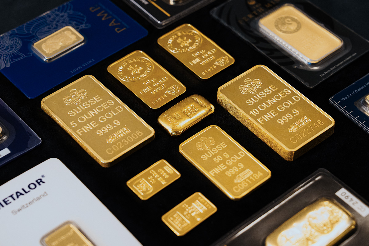 Assorted gold bars in various sizes, including 5 ounce, 10 ounce, and 50 gram Suisse fine gold bars, alongside packaged Metalor and PAMP bars