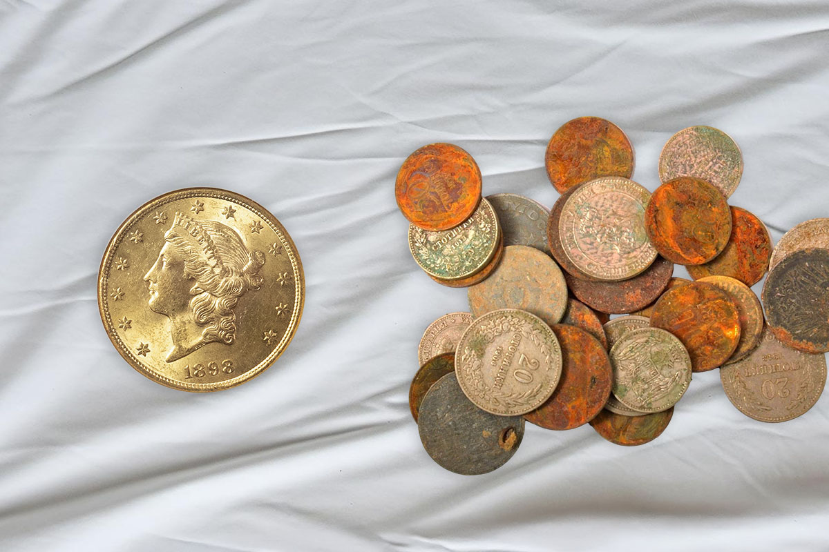 A bright, untarnished gold coin with a Liberty head design dated 1898 next to a pile of heavily corroded coins showing orange, brown, and green discolouration