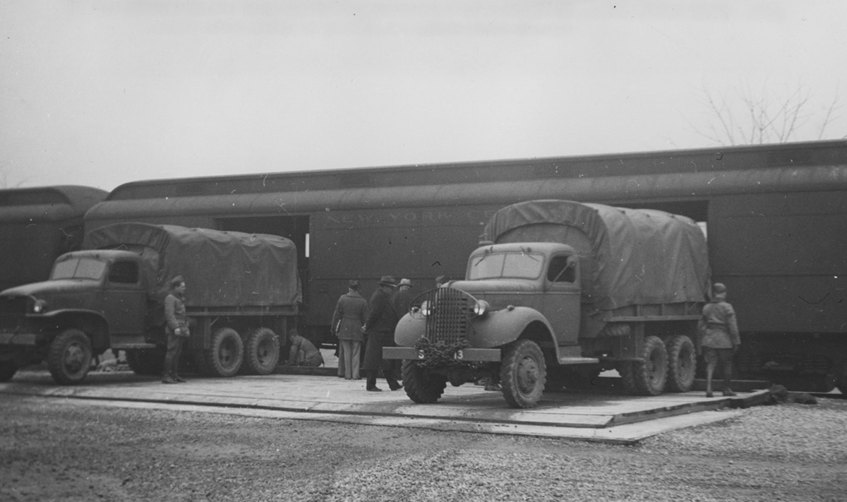 Image of train and US army trucks.